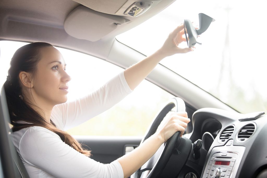 Young woman yawning in the car Young woman, a drowsy drive, yawning sitting at the drivers seat in the car, causing a danger of driving because of a serious lack of sleep